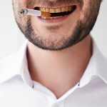 smoking man with dirty yellow teeth