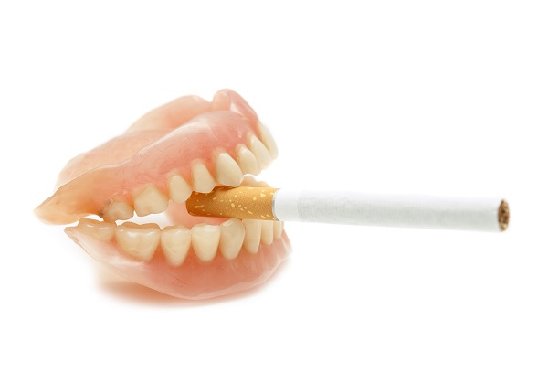 Dentures with a cigarette 