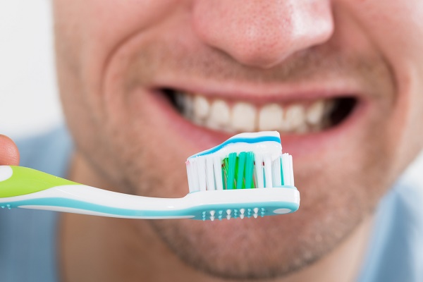 Closeup of mid adult man brushing teeth