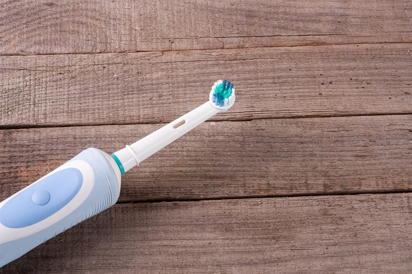 Electric Toothbrush on an old wooden background.