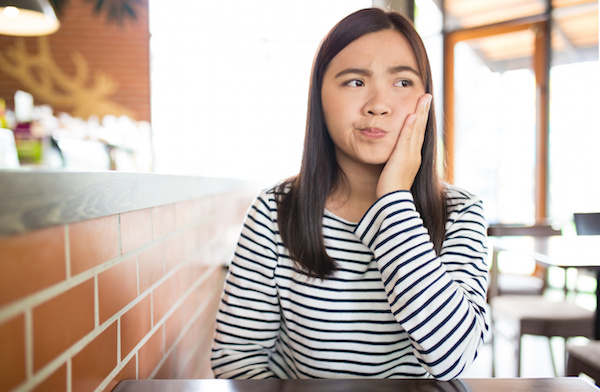 Woman has tooth ache