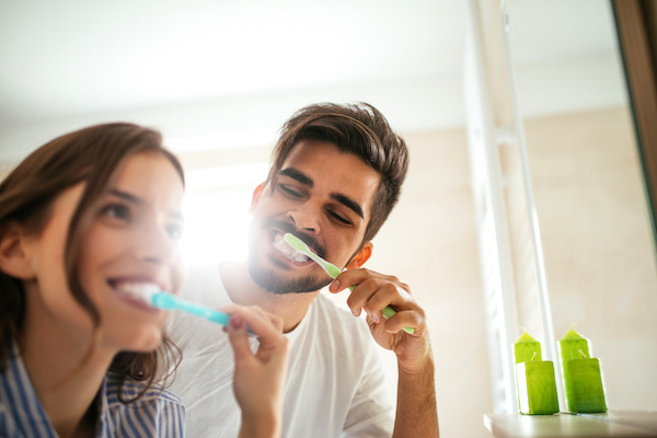 Couple doing a morning hyginene together.