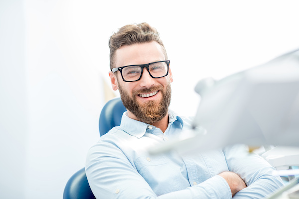 Handsome businessman with great smile sitting on the dental chair