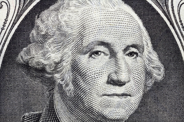 Macro detail of George Washington's face on the US one dollar bill.