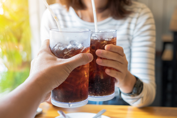 Men and Woman hand giving glass of cola.Glass of cola ,Soft drinks with ice, sweethart or buddy