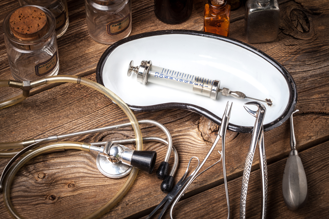 Retro medicalinstruments on a wooden table. Shallow depth of field.