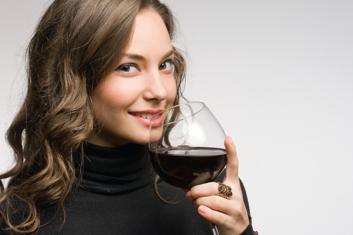Cool fashionable young brunette woman tasting great wine.