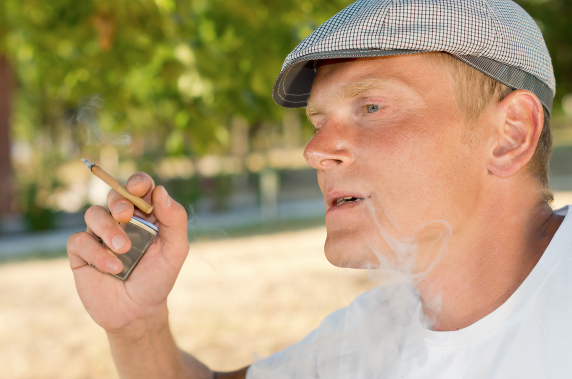 man with substance abuse problem smoking, not worrying about oral care.