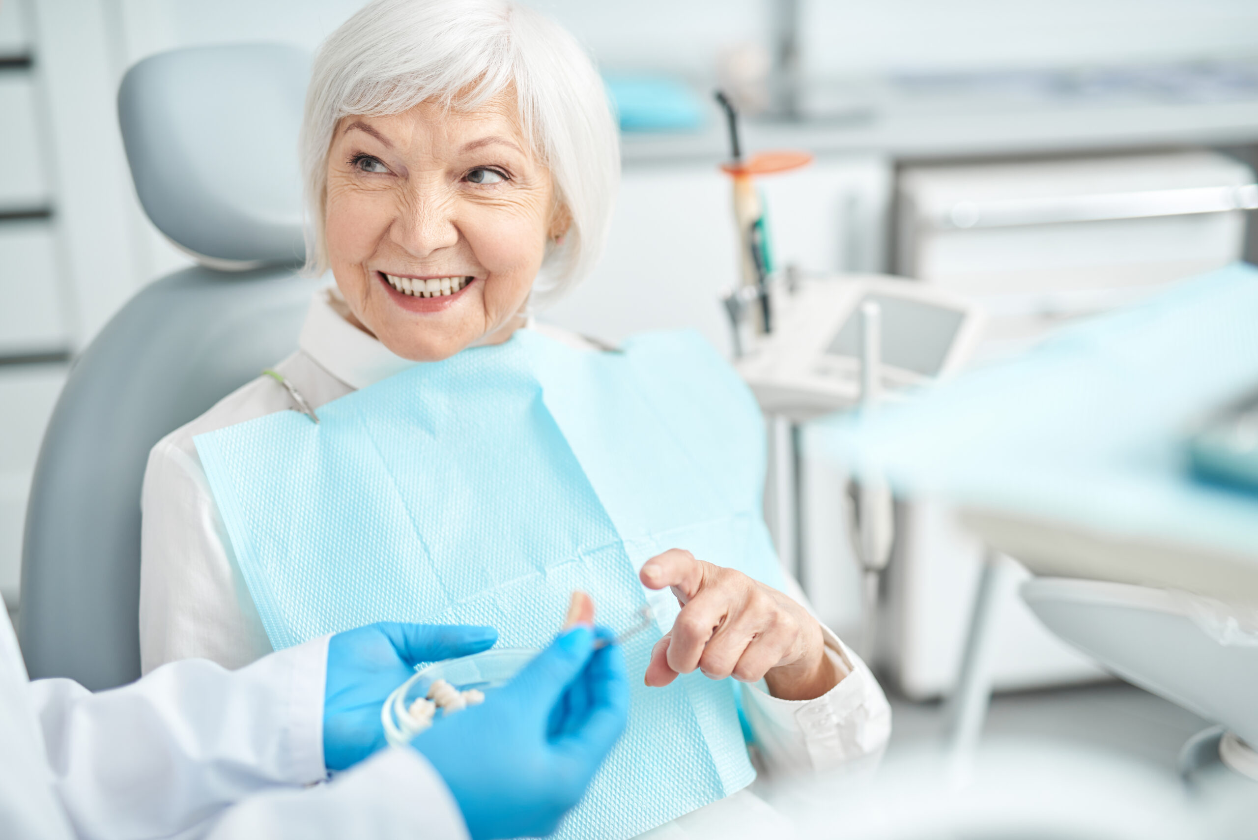 Smiling elderly woman looking at her doctor stock photo problems