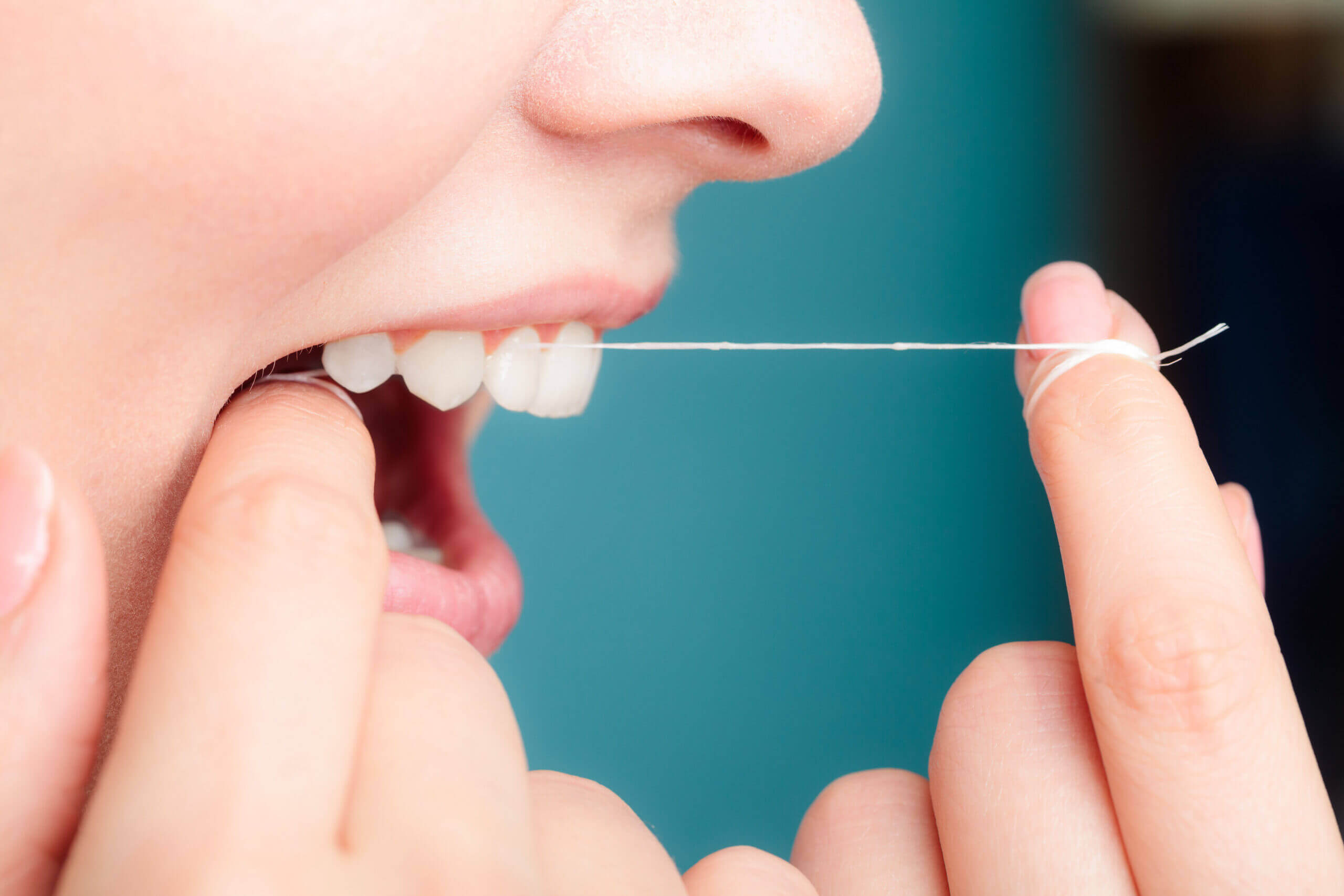 flossing Oral hygiene and health care. Smiling women use dental floss white healthy teeth.