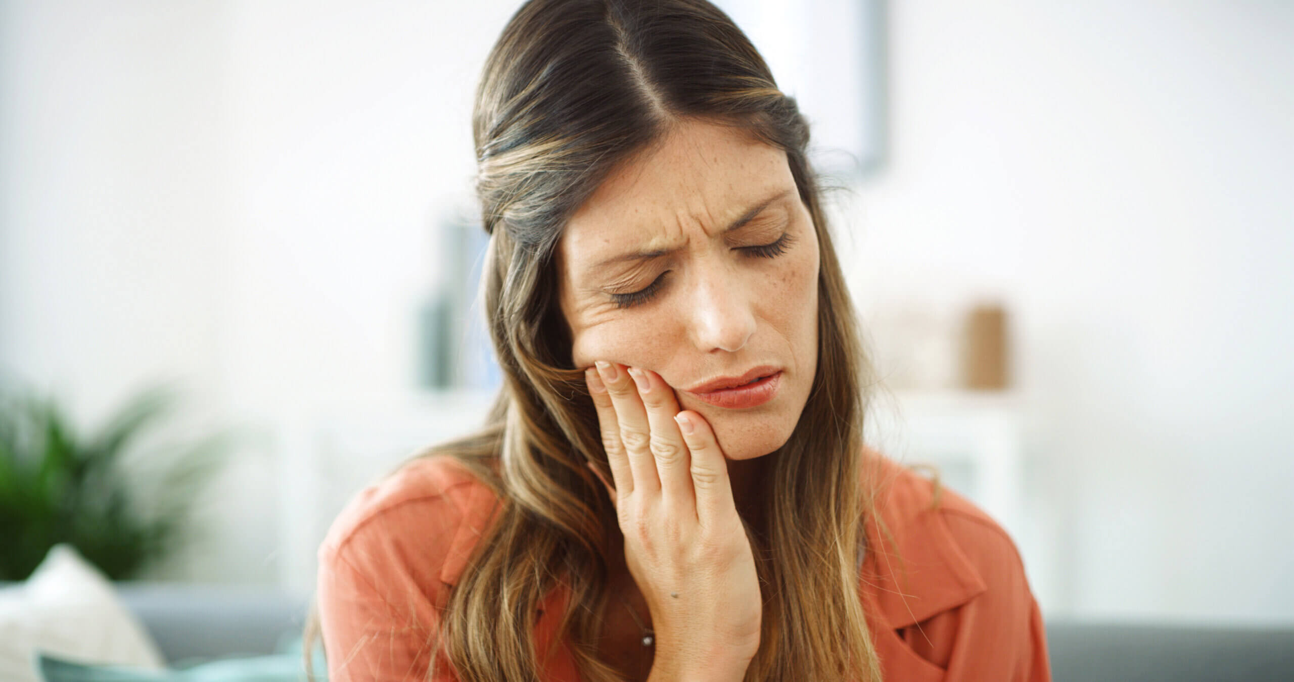 Woman, sore mouth and toothache at house from dental cavity, tooth extraction and gum infection. Female person, discomfort and oral decay with gingivitis, root canal injury and treatment for filling.